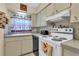 Kitchen with white stove and cabinets at 5711 S Coolidge Ave, Tampa, FL 33616
