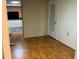 Spacious living room with laminate flooring and access to other rooms at 5711 S Coolidge Ave, Tampa, FL 33616