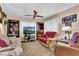 Living room with floral sofa, TV, and built-in shelving at 5711 S Coolidge Ave, Tampa, FL 33616