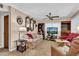Living room with floral sofa, TV, and built-in shelving at 5711 S Coolidge Ave, Tampa, FL 33616