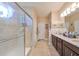 Elegant bathroom with granite countertops and a walk-in shower at 6516 Salt Creek Ave, Apollo Beach, FL 33572