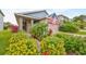 House exterior with walkway, lush landscaping, and American flag at 6516 Salt Creek Ave, Apollo Beach, FL 33572