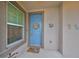 Blue front door featuring a seashell wreath at 6516 Salt Creek Ave, Apollo Beach, FL 33572