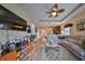 Open living area showcasing hardwood floors and a large flat-screen TV at 6516 Salt Creek Ave, Apollo Beach, FL 33572