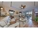 Bright living room with a large sectional sofa and access to a patio at 6516 Salt Creek Ave, Apollo Beach, FL 33572