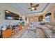 Open living area showcasing hardwood floors and a large flat-screen TV at 6516 Salt Creek Ave, Apollo Beach, FL 33572