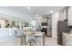 Open concept kitchen with island, granite countertops, and stainless steel appliances at 684 157Th E Ct, Bradenton, FL 34212
