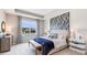 Main bedroom with a large bed and a blue and white color scheme at 688 157Th E Ct, Bradenton, FL 34212
