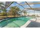 Relaxing screened-in pool with ample space for lounging at 707 Albee Farm N Rd, Nokomis, FL 34275