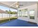 Screened porch with a ceiling fan and view of the backyard at 7652 Rathdown Ln, Wesley Chapel, FL 33545