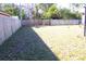 Large backyard with wooden fence and open grassy area at 7809 Dover N Ct, St Petersburg, FL 33709