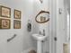 Clean bathroom with pedestal sink, decorative art and grab bar at 835 7Th N Ave, St Petersburg, FL 33701