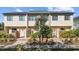 Tan three-story townhome with a green roof and landscaping at 835 7Th N Ave, St Petersburg, FL 33701