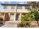 Tan three-story townhome with a green roof and landscaping at 835 7Th N Ave, St Petersburg, FL 33701