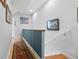 Upstairs hallway with wood floors and artwork at 835 7Th N Ave, St Petersburg, FL 33701