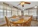 Bright dining room features a wooden table with seating for six and large windows at 107 W Saint Lucia Loop, Apollo Beach, FL 33572