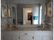 Bright bathroom with double sinks and mirrored cabinets at 12172 Wild Acres Rd, Largo, FL 33773