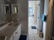 Clean bathroom with double vanity and stained glass at 12172 Wild Acres Rd, Largo, FL 33773