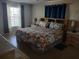 Main bedroom with floral bedding and built-in shelves at 12172 Wild Acres Rd, Largo, FL 33773