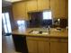 Kitchen with wood cabinets and a double sink at 12172 Wild Acres Rd, Largo, FL 33773