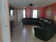 Living room featuring a large sectional sofa and tile flooring at 12172 Wild Acres Rd, Largo, FL 33773