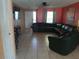 Living room featuring a large sectional sofa and tile flooring at 12172 Wild Acres Rd, Largo, FL 33773