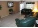 Living room features tile floors and flat screen TV at 12172 Wild Acres Rd, Largo, FL 33773