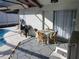 Small patio with table and chairs near pool at 12172 Wild Acres Rd, Largo, FL 33773