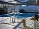 Inviting pool and spa with patio furniture at 12172 Wild Acres Rd, Largo, FL 33773