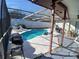 Relaxing pool area with patio furniture and grill at 12172 Wild Acres Rd, Largo, FL 33773
