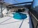 Inviting kidney-shaped pool with screened enclosure at 12172 Wild Acres Rd, Largo, FL 33773