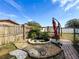 Landscaped backyard with pond feature and patio at 12233 Bartkus Ct, Hudson, FL 34669