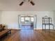 Living room with wood floors and view of sunroom at 12233 Bartkus Ct, Hudson, FL 34669