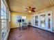 Bright sunroom with ceiling fan and backyard access at 12233 Bartkus Ct, Hudson, FL 34669