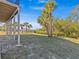 Landscaped backyard with path leading to waterfront at 1614 Sea Breeze Dr, Tarpon Springs, FL 34689