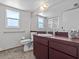 Clean bathroom with toilet, sink, shower, and grab bars at 1614 Sea Breeze Dr, Tarpon Springs, FL 34689