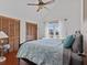 Bedroom with a king-size bed, ceiling fan and wood floors at 1614 Sea Breeze Dr, Tarpon Springs, FL 34689