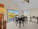 Bright dining area with table and chairs, providing a view of the deck at 1614 Sea Breeze Dr, Tarpon Springs, FL 34689