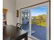 Bright dining room with sliding glass doors leading to deck and water views at 1614 Sea Breeze Dr, Tarpon Springs, FL 34689