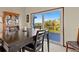 Dining room with dark wood table and access to a deck with water views at 1614 Sea Breeze Dr, Tarpon Springs, FL 34689