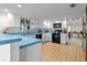 Kitchen with light blue countertops and black appliances at 1614 Sea Breeze Dr, Tarpon Springs, FL 34689