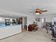 Open living space with piano, office area and view to kitchen at 1614 Sea Breeze Dr, Tarpon Springs, FL 34689
