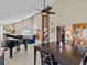 Living room with piano and views into kitchen and dining area at 1614 Sea Breeze Dr, Tarpon Springs, FL 34689