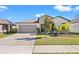 Single-story house featuring a gray garage and small front yard at 16632 Sunburst Lake St, Wimauma, FL 33598