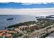 Aerial view of waterfront condos with marina, pool, and lush landscaping at 1695 Pinellas Bayway S # D1, Tierra Verde, FL 33715