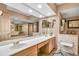 Bathroom with double vanity, a large mirror, and a shower at 1695 Pinellas Bayway S # D1, Tierra Verde, FL 33715