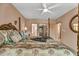 Bedroom with a large four poster bed and ceiling fan at 1695 Pinellas Bayway S # D1, Tierra Verde, FL 33715