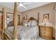 Guest bedroom with a post bed, dresser, and ceiling fan at 1695 Pinellas Bayway S # D1, Tierra Verde, FL 33715