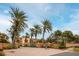 Community entrance with gated access and palm trees at 1695 Pinellas Bayway S # D1, Tierra Verde, FL 33715