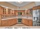 Well-equipped kitchen with wood cabinets, tile flooring, and stainless steel appliances at 1695 Pinellas Bayway S # D1, Tierra Verde, FL 33715